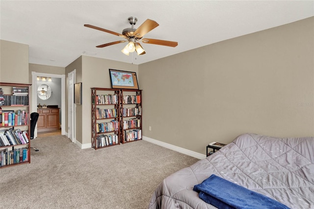 bedroom featuring ceiling fan, ensuite bathroom, and light carpet