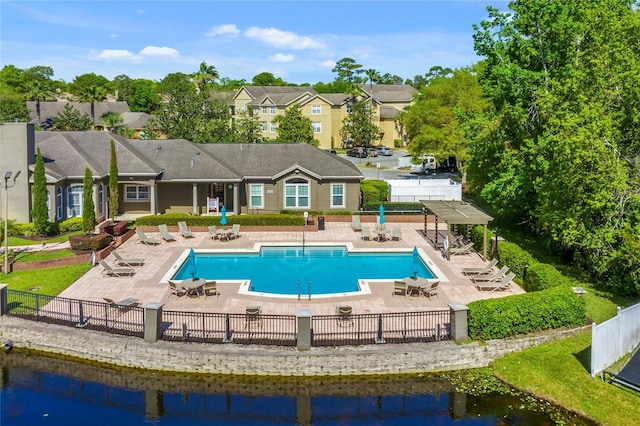 view of swimming pool with a water view and a patio area