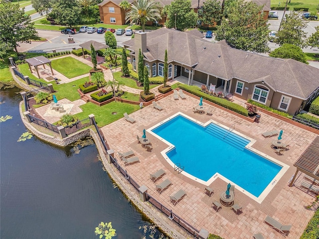 view of swimming pool featuring a water view and a patio area