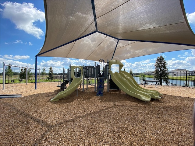 view of playground with a water view