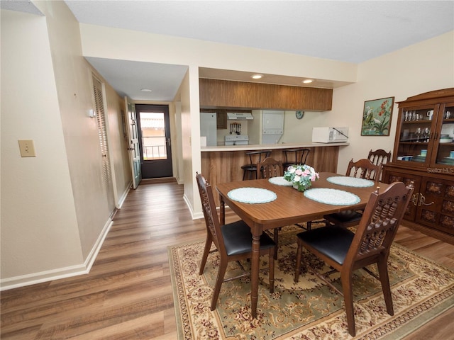 dining space with dark hardwood / wood-style flooring