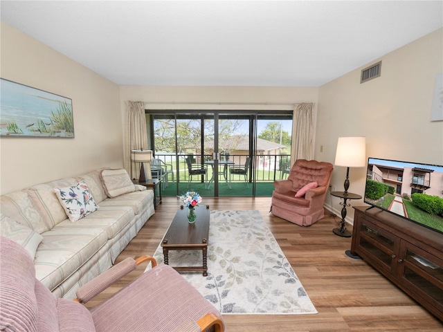 living room with light hardwood / wood-style flooring