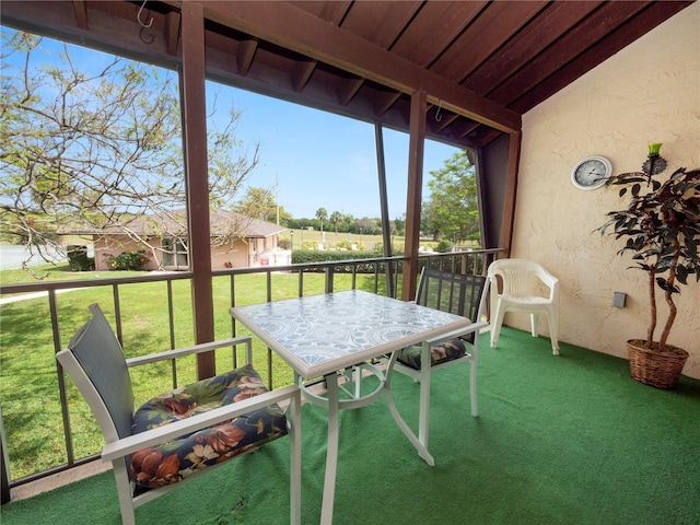 unfurnished sunroom featuring lofted ceiling