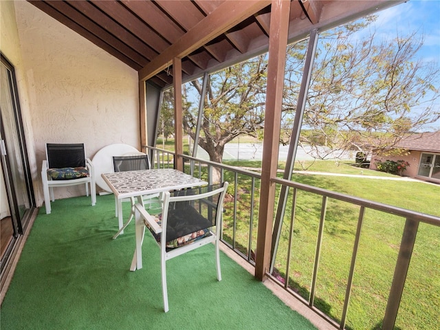 unfurnished sunroom with lofted ceiling