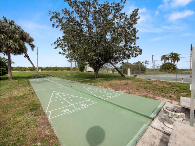 surrounding community with a yard and tennis court