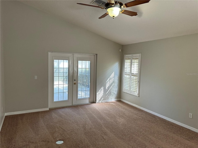 unfurnished room with french doors, ceiling fan, vaulted ceiling, and carpet