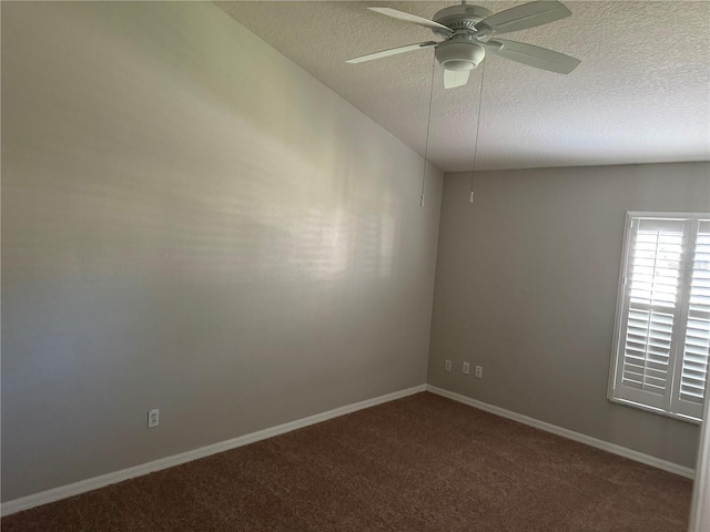 spare room featuring ceiling fan, lofted ceiling, carpet, and a textured ceiling