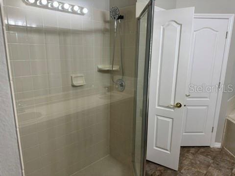 bathroom featuring a shower with door