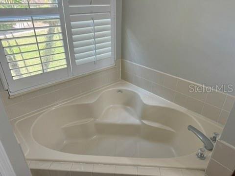 bathroom with tiled bath