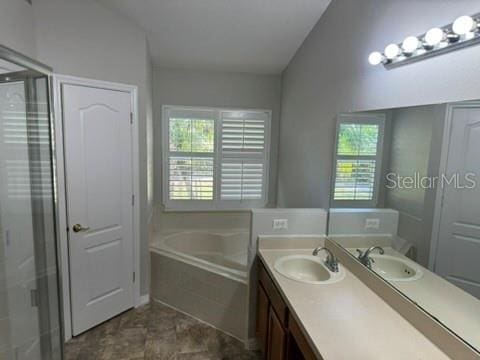 bathroom featuring vanity, lofted ceiling, and plus walk in shower