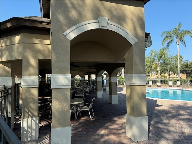 view of pool featuring a patio and ceiling fan