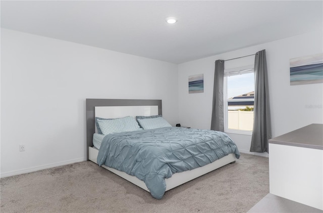 bedroom featuring light carpet