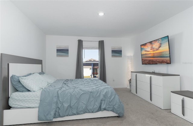 bedroom featuring light carpet