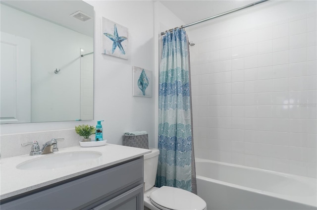 full bathroom featuring vanity, shower / bath combination with curtain, and toilet