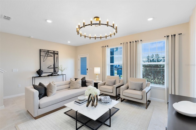 living room with light tile patterned floors and a notable chandelier