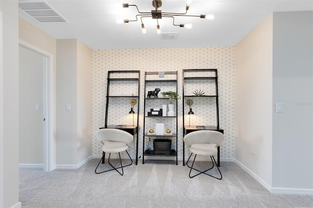 sitting room with light colored carpet and an inviting chandelier