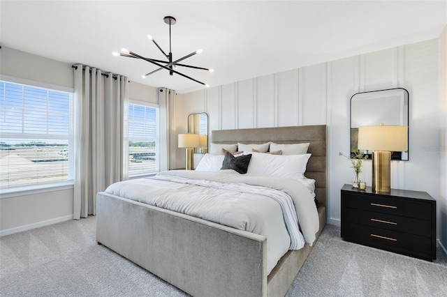 carpeted bedroom featuring an inviting chandelier