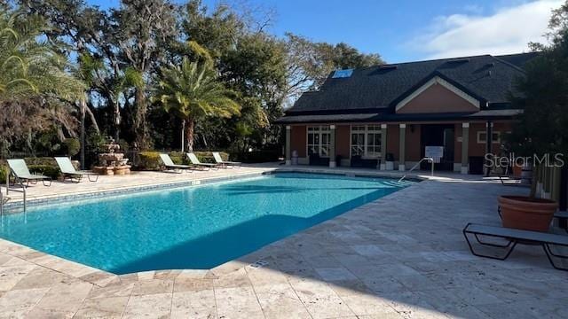 view of swimming pool with a patio