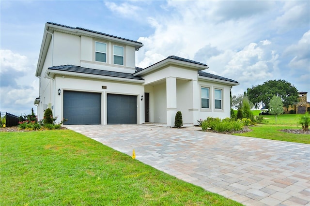 view of front of property featuring a garage and a front lawn