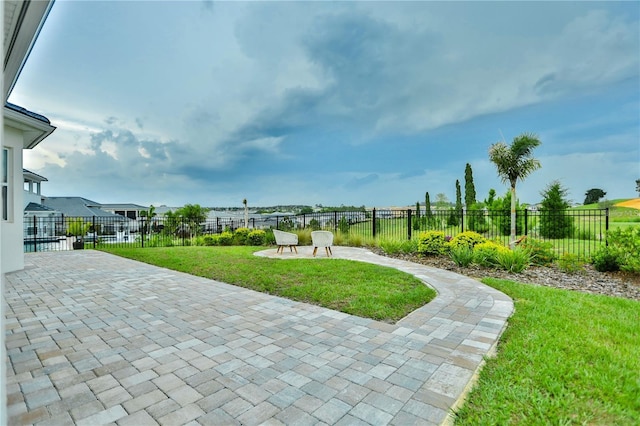 view of community featuring a yard and a patio