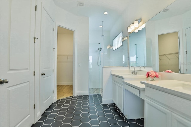 bathroom featuring vanity and tiled shower