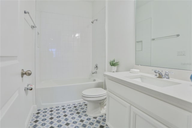 full bathroom featuring tiled shower / bath, vanity, and toilet