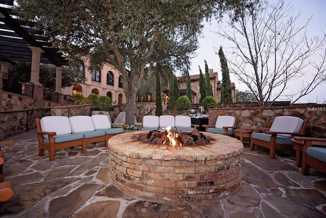 view of patio with a pergola and a fire pit