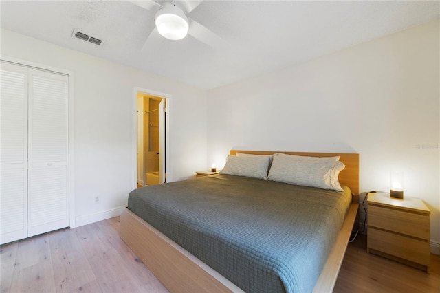 bedroom with ceiling fan, light hardwood / wood-style floors, and a closet