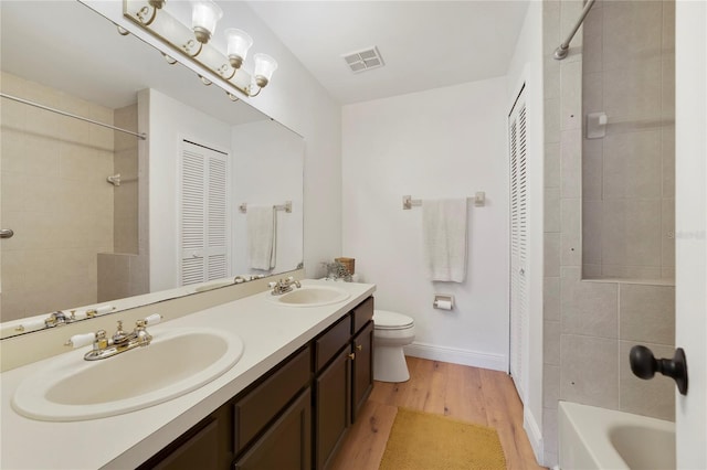 bathroom with vanity, hardwood / wood-style floors, and toilet