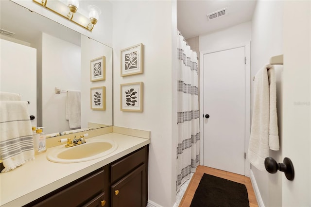 bathroom with vanity, hardwood / wood-style floors, and curtained shower