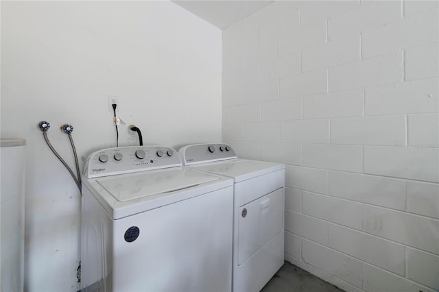 clothes washing area with separate washer and dryer