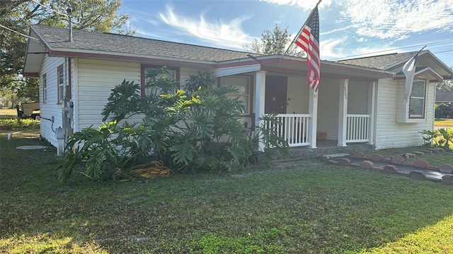 view of front of house with covered porch and a front yard