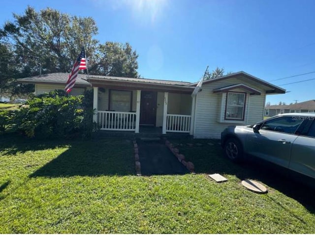 view of front of property with a porch and a front yard