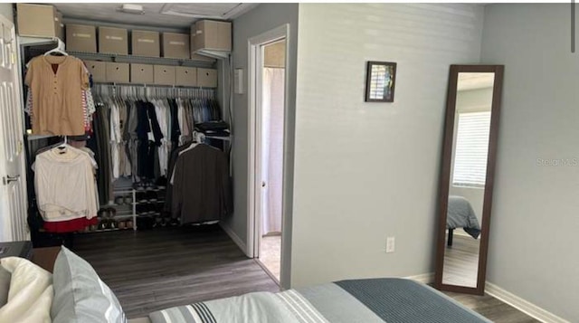 bedroom with dark hardwood / wood-style floors and a closet