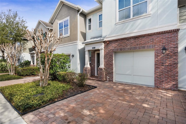 townhome / multi-family property featuring a garage