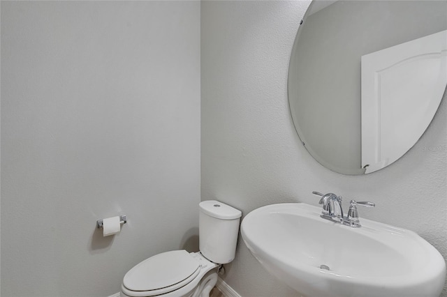 bathroom featuring sink and toilet