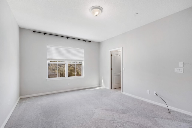 empty room featuring light carpet