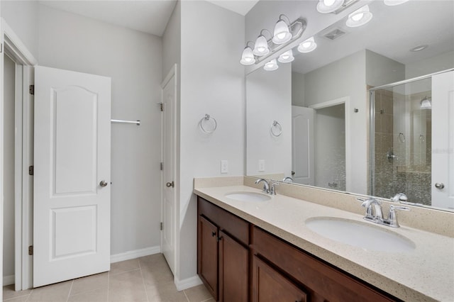 bathroom with tile patterned flooring, vanity, and an enclosed shower