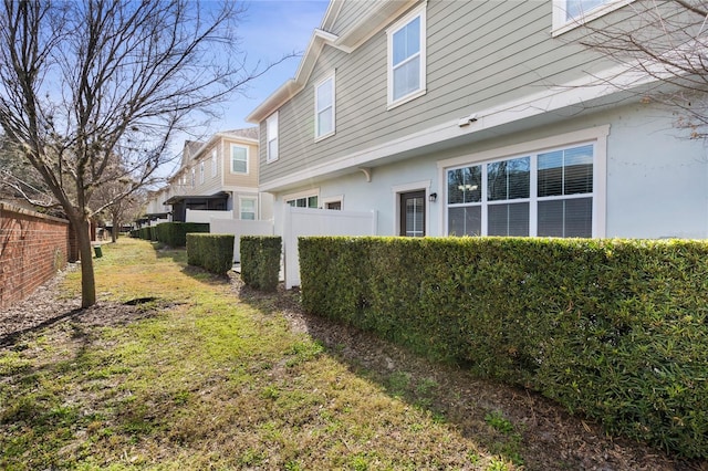 view of home's exterior with a lawn