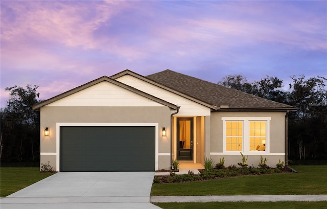 ranch-style home featuring a garage and a yard