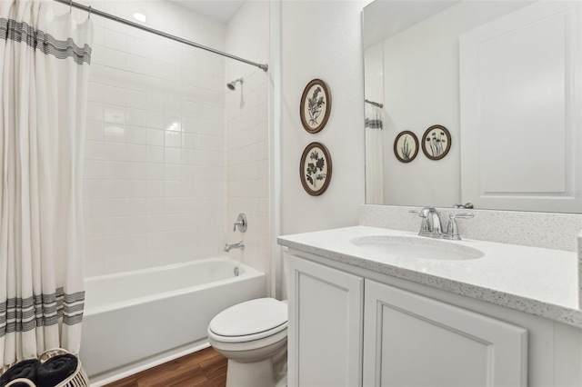 full bathroom featuring wood-type flooring, toilet, shower / bath combo with shower curtain, and vanity