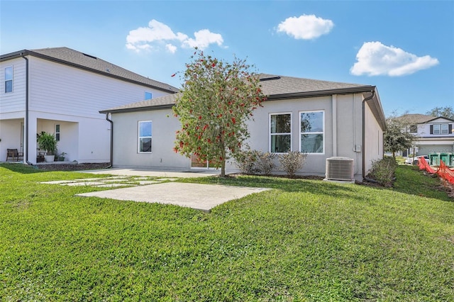 back of property featuring a lawn, central AC, and a patio area