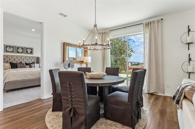 dining room featuring dark hardwood / wood-style flooring and a chandelier