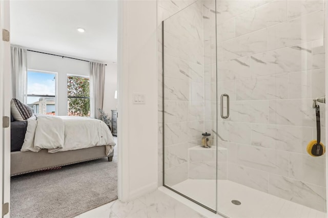 bathroom with a shower with door