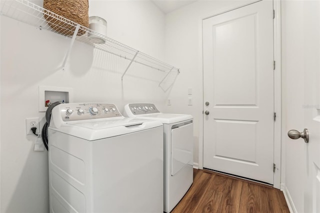 washroom with dark hardwood / wood-style flooring and independent washer and dryer