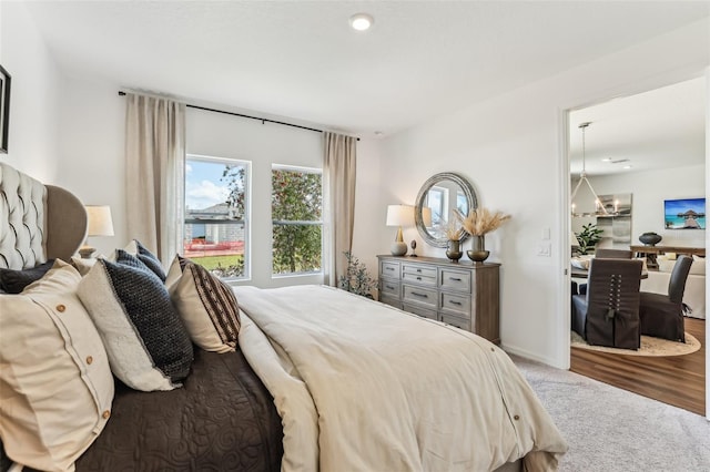 carpeted bedroom featuring a chandelier