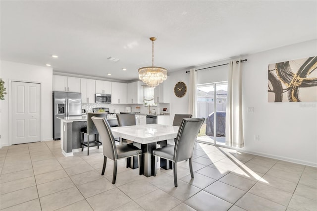 dining space with light tile patterned flooring and a notable chandelier