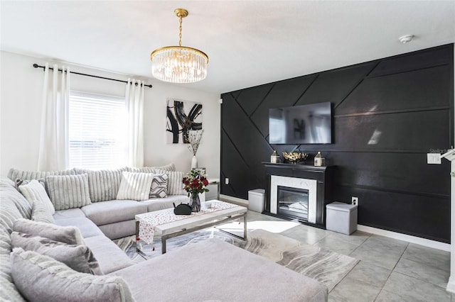 living room featuring a fireplace, a chandelier, and light tile patterned flooring