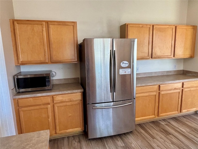 525 Aster Dr, Davenport, FL 33897 - kitchen featuring light wood finished floors, light countertops, and appliances with stainless steel finishes