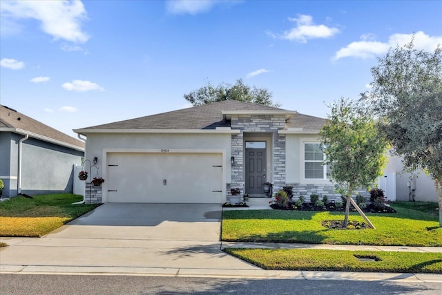 view of front of home featuring a garage and a front lawn